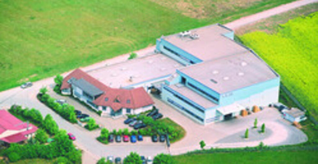 A Saint Gobain site in Wertheim Germany surrounded by green fields.