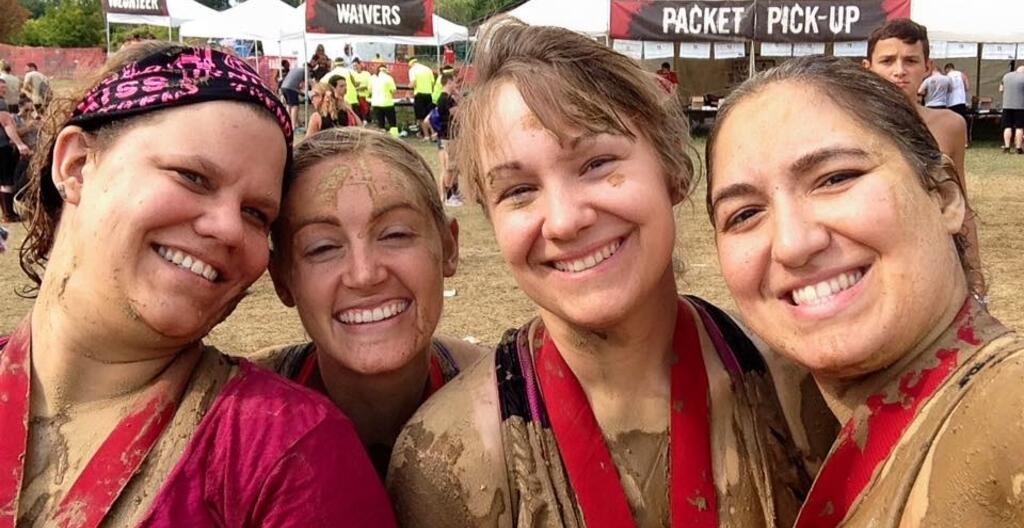 Four individuals posing for a photo after completing the Ohio Warrior Dash