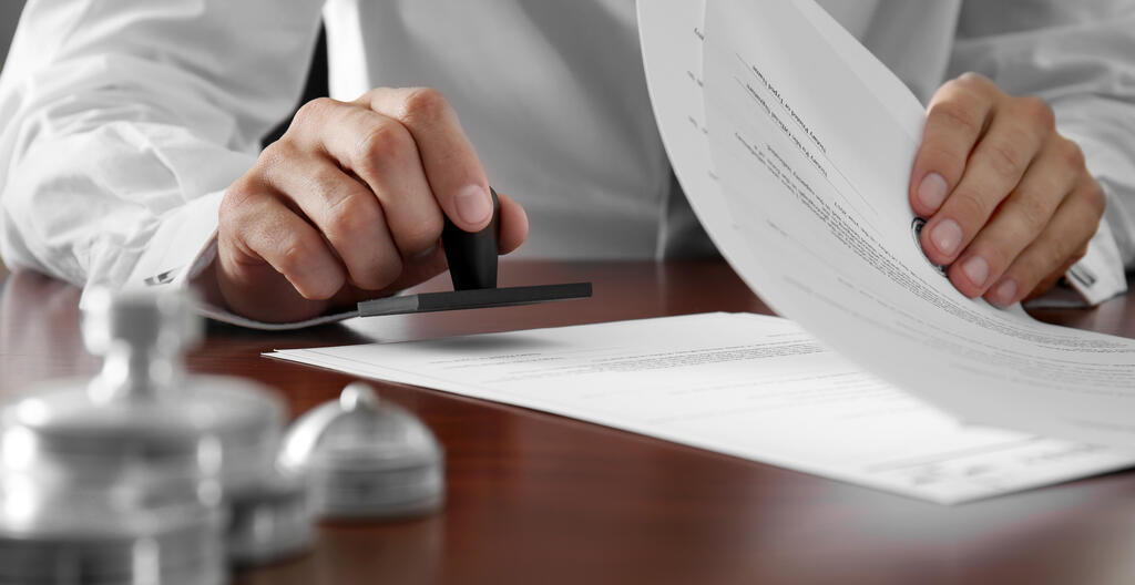 An individual stamping some documents
