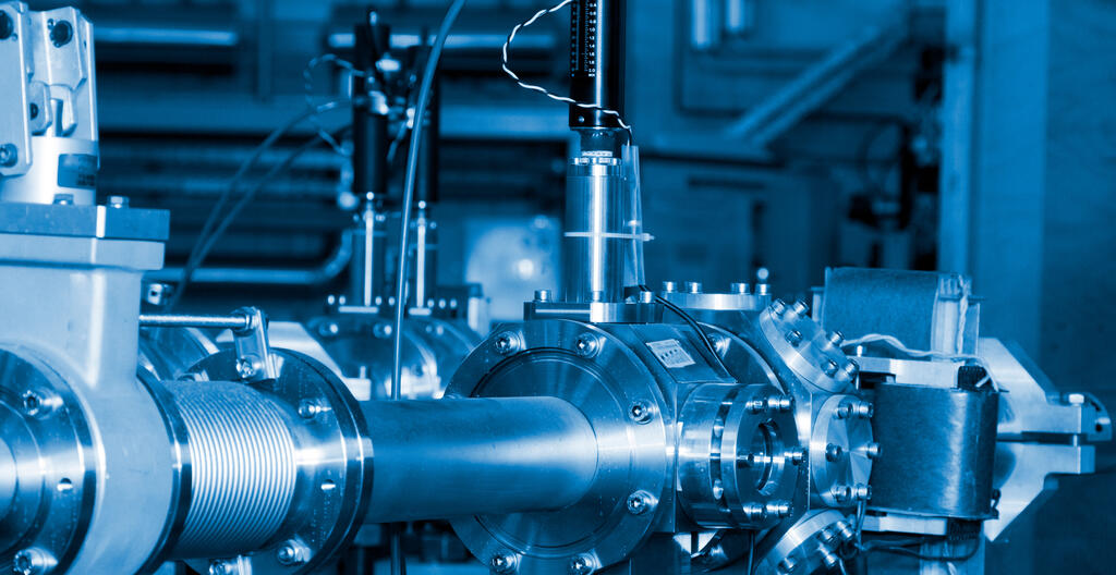 Important parts of ion beam accelerator in a laboratory setting with a blue filter