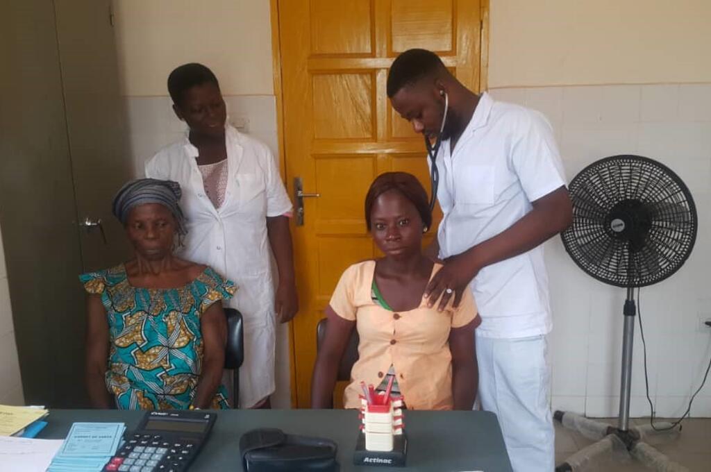 Two medical professionals examining patients
