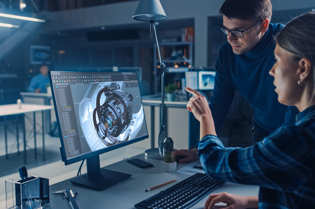 A man and woman looking at a computer-generated 3D model of a jet engine