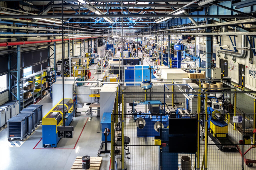 The manufacturing site of Kolo, POland from overhead showing various CNC milling machines, 5S items and walkways