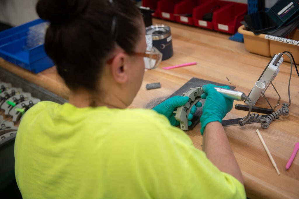 Omniseal Solutions Production Operator Checking a Carbon Composite Aerospace Component