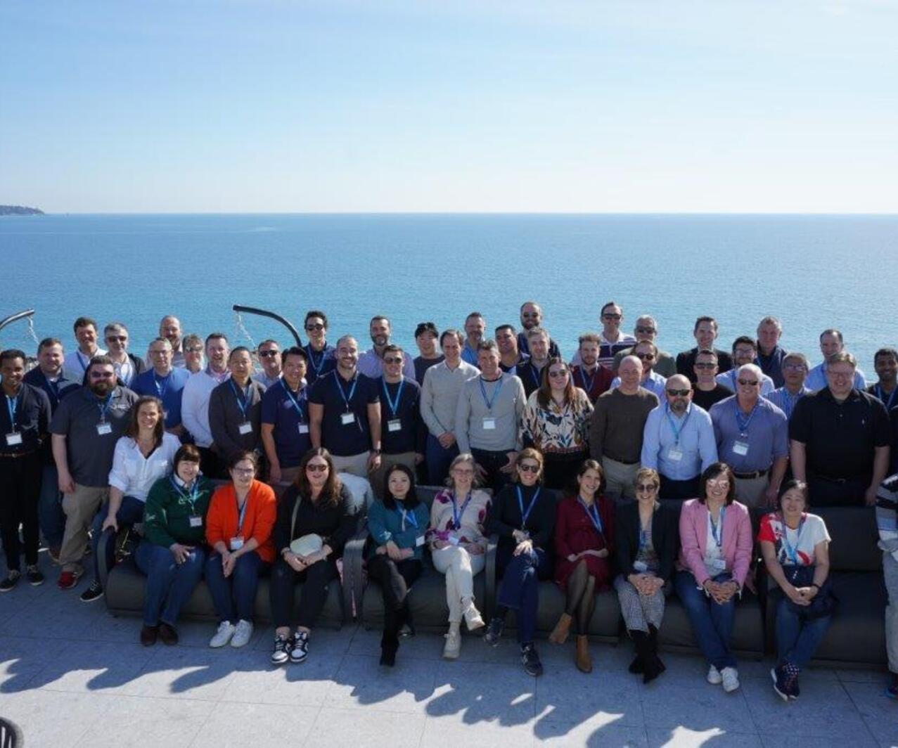 A group of people standing on the shore line representing the Omniseal Solutions Capture Team