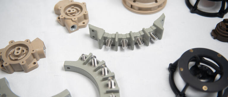 Image of various carbon composite components (CRFPs) specifically designed for the aviation industry.