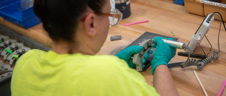 Omniseal Solutions Production Operator Checking a Carbon Composite Aerospace Component